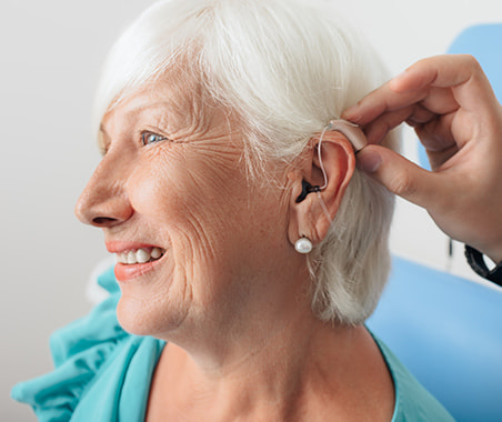 Young woman having ear examined