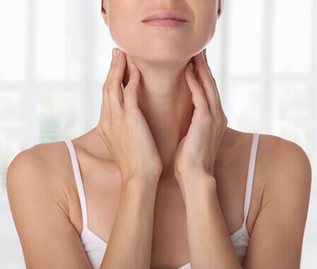 Woman touching her neck