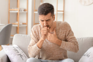 man coughing