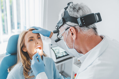 Woman having throat examined