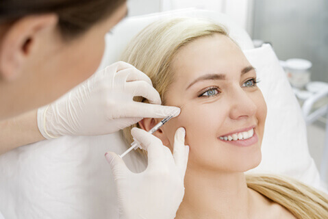 Woman having dermal filler injection